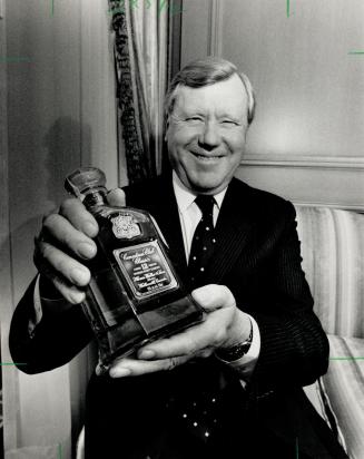 New whisky: Allied Lyons chairman Sir Derrick Holden Brown shows off Canadian whisky headed for U.S.