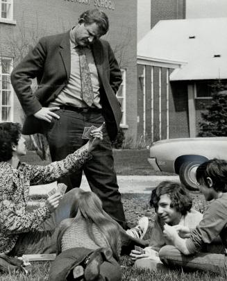 Principal Warren Hyland talks with students on the lawn of Bathurst Heights Secondary School after classes