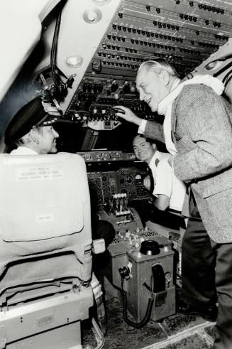 Another world: Air Vice-Marshal George Howsam, 86, of Victoria, chats with Captain Gordon Morgan and first officer Kip Chaput in the cockpit of the 747