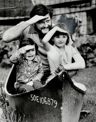 Smooth sailing: Paul Howard plays a game of pirates with children Peter, 4, and Penny, 6, in a dory he made