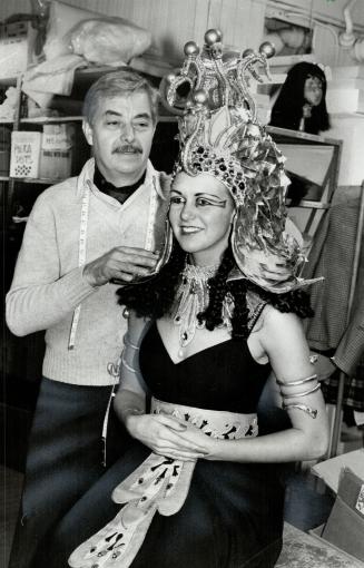 M-believe time: Costumes couturier Warren Hughes dresses his daughter Jeannie, in a Cleopatra outfit