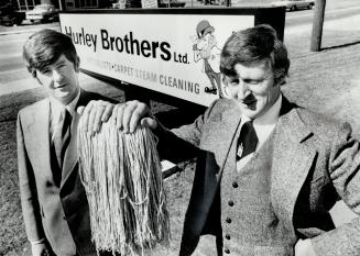 The hurley brothers: Michael Patrick, left, and Richard Peter, came to Toronto from County Cork, Ireland, and-with an assist from the 'little man' in teh centre-have built their office cleaning company into one of the five biggest in Metro