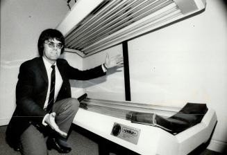 Under the lights: Bill Huurdeman displays one of the ultraviolet tanning beds made by his firm, Uvalux International, in Woodstock