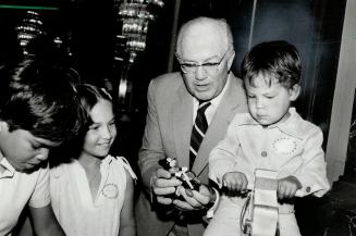 Play time: Irwin Toy boss Arnold Irwin shows off one of his products to junior shareholder Edward Gough