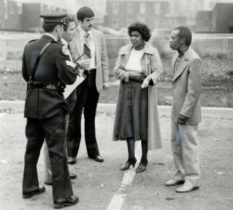 Victims's parents: Wesley Jones and his wife talk to Metro Police Constable Gary Walton (left) and 31 Divison sergeants Gary Greaves and Robert Cowan after their 21-year-old son, Ray, was shot and killed in front of a townhouse in the Jane St