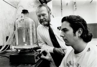Bubbling away trouble? Graduate student Eric Bauer, right, tests ozone experiment for Dr. Phillip Jones of the University of Toronto's Institute for Environmental Studies.