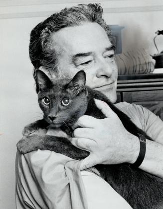Rolf Kalman with simon. Cat lent its name to his owner's company