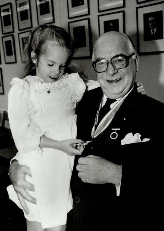 Nice medal, granddad: Lesley Kane, 6, admiries the award won by her grandfather, Jim Kane, who was honored Friday for his volunteer work with the Canadian Red Cross Society
