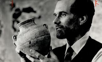 Royal Treasures: Dr. Ed Keall, an archeologist and curator-in-charge of the Rom's West Asian department holds a centuries-old piece of pottery. He has spent five years of his career working in the Middle East.