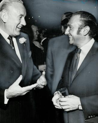Celebrating birthday: David Kinnear, chairman of T. Eaton Co. Ltd., chats with Honest Ed Mirvish during Eaton's 100th birthday party