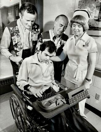 Quadraplegic Barry King, 25, operates communication module system at Scarborough General Hospital as Wishing Well Lions Club members Ray Hutchins (left) and Rocky Visconti, and head nurse Myfanwy Williams look on