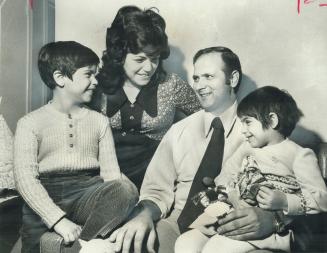 After Escaping from Greence, CP Air steward Nick Kladitis, 33, is reunited with his wife, Frieda, andhis children, John and Christine, at their home in Mississauga