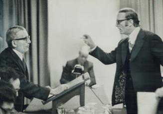 Gesturing Angrily, lawyer Lloyd Fogler, right, waves his hand at Mark Levy, chairman of a tumultuous special meeting of shareholders of Seaway Multi Corp
