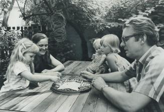 Game of chinese checkers is enjoyed by Professor James Lemon, his wife Carolyn and children Catherine, 1, Janet, 4, and margaret, 9, in their Walmer Road home. Although earning a salary of $15,000 teaching geography at the University of Toronto, Dr. Lemon describes his living as relatively frugal and finds the family budget getting tight. Although he has a car, he walks to work.