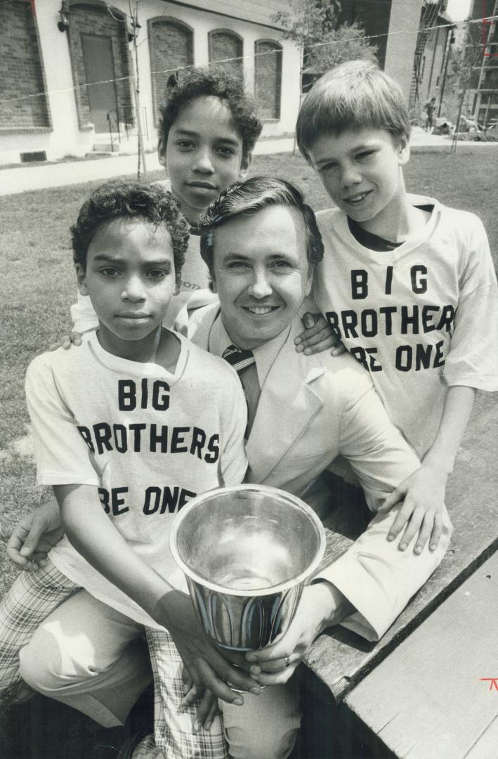 John Liston, the agency's executive director, with (from left) Derek and David Brin, 11 and 13, and Tommy Hall, 10