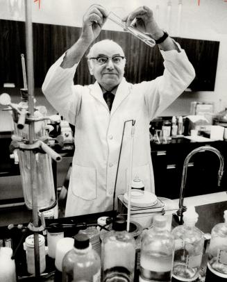 Dr. Ernest Knapp. Chemist. At work in his Don Mills laboratory