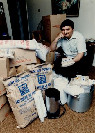 Help needed: Fred Koruntoff sits in the living room of his home, surrounded by food donated to his free breakfast program for the needy
