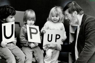 . . . and away: Sidney Ledson, who claims he can put any child well on the way to reading in just 60 days, uses letter and combinations of letters to help three tiny pupils. Left to right are Michael D'Alessandro, 3, Sarah Jayne Puppi, 2, and Jacqueline Symons, 3. Ledson has written two books on the subject.
