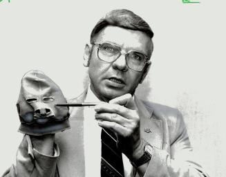 War on burns: Plastic surgeon Dr. Dwayne Larson demonstrates mask used to prevent scar formation on face of burn victim.