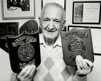 Nathan Lastman: Honorary president of the Toronto Hebrew Benevolent Society holds the plaques that he received as a two-time president