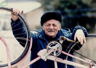 Bicycle doctor: Don (Beanie) Lehman holds up one the bicycles he's fixing in his backyard