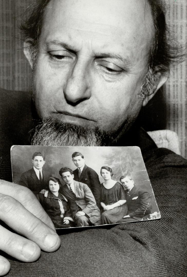 Horror relived: Nathan Peipciger, holding a photo of family members, all of whom died in Nazi concentration camps except his father (bafck row, centre), says reliving Nazi horrors was necessary to bring Emst Zundel to justice