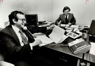 Lorne Levy (foreground) is 80 per cent-owner of Leeburn Securities. On the other side of the desk is partner Aubrey Katz.