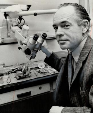 A medical first was performed by Dr. William Lougheed, a neurosurgeon and assistant professor at the University of Toronto, when he took vein from a woman's leg and transplanted it into her head to replace a blocked artery that caused a stroke. He's shown with the type of microscope used in surgery.