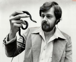 Snakes can be fun, says Jim Lovisek. That's an all-black garter snake he's holding.