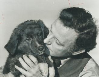 A stray pup finds sanctuary in the arms of Alan McGinn, founder of a new organization for animal-lovers to provide refuge for lost dogs and cats that might otherwise be used for medical research