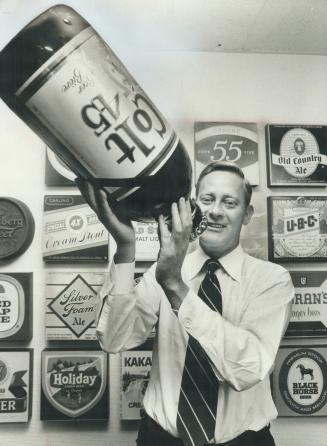 Roderick McInnes holds an out-size bottle of one of the new beers he hopes will help Carling O'Keefe increase its share of the Canadian beer market