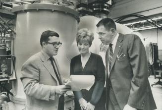 Mrs Peg McKay joins her husband Henry (right) and Dr Rod Tennyson is examining a list of sightings of unidentified flying objects