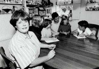 Table talk: Barbara McDonald gets ready to call the family's weekly meeting to order as husband, Randy, chats with the kids, from left, Kim, 15, Lindsay, 6, Caitlyn, 6 and David, 11