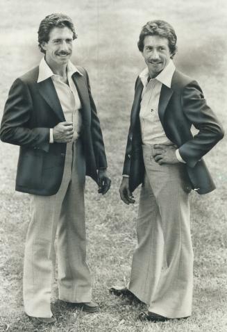 Identical twins Michael and Martin McNamara, co-owners of the Twin Dragon Kung-Fu Club wear navy blue blazers and gray slacks from the Short Man, a store a 545 Queen St