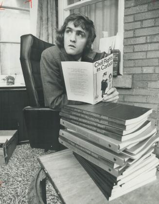 Randy McRoberts, who runs Toronto branch of Self-Counsel Press, shows some of the books his firm publishes the help laymen interpret some of the simpler facets of law