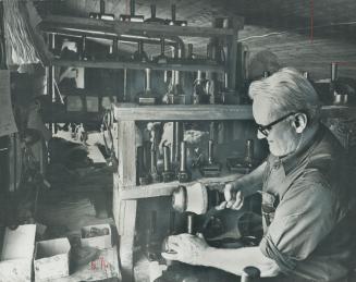 Working in a turkey coop that has been converted to the Marzo Glove Company, Ilic Marzo die-cuts glove forms from sheets of leather