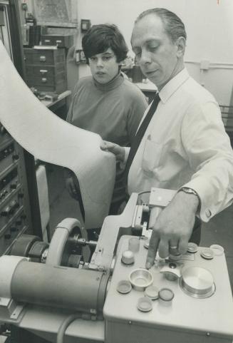 Studying rocks is a complicated business. Here Dr. Joseph Mandarino shows 13-year-old Steven Berdock how to operate an x-ray spectograph which is used by the museum for analyzing chemical materials in specimens.
