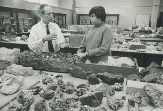 Hundreds of rocks are displayed in the mineralogy department laboratory of the Royal Ontario Museum as Dr. Joseph Mandarino, head of the department, talks with 13-year-old Steven Berdock. Steven began collecting specimens two years ago and is proud of the display he has at home. The museum's collection is one of the fienst in North America and among the best ten in the world.