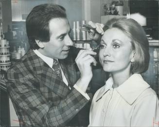 Pablo Mazoni, Elizabeth Arden's creative director who is the only make-up artist ever to win the Coty Award for his work, applies eye shadow for Mrs