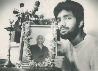 Family stymied: Bagavathsingh Marakathalinga Sivam holds photo of father, whose letter, left, did not sway visa officials.