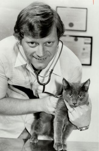 Praised by peers: The Ontario Veterinary Association has named Dr. Paul McCutcheon 1979 vet of the year. Here is his East York office, the vet works on a patient named Askhim. The relationship between people and animals, he says, is symbolic of our ability to live with nature.