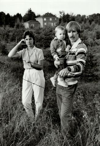 Frightened for future: Helen and Robert MacDonald, holding their 17-month-old son Kyle, stand in a field near their dream home near Starkville