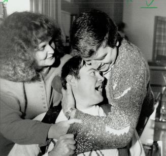 Victory hug: Vincent MacDonald is hugged by sister Patsy Foley and her husband Ray after winning $4