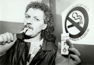 Stairwell smoke: Wayne McEwen, $46 game ticket in hand, ignores a no-smoking sign at first smoke-free game at Maple Leaf Gardens last night