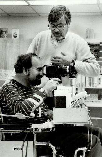 Gifted photographer: Tim Morris helps peter McGowan with a camera mounted on McGowan's wheelchair