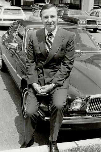 Yes, it's an import: John Mackie, chairman of the Automobile Importers of Canada and president of Jaguar Rover Triumph Canada, perches on his own Jaguar