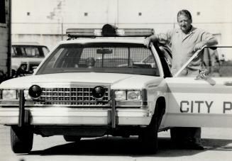 Cruisers for rent: Bruce McLean shows off one of his police cars, which he hires out for use on film sets