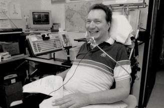 Bed-top publisher: Quadriplegic jack McLellan operates a publishing business from his bed at Whitby General Hosptial.