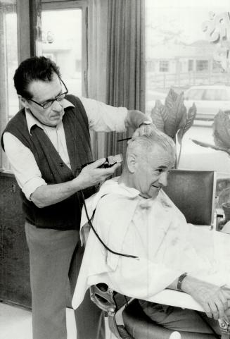 Precision cut: Barber Joe Mager gives long-time customer Jimmy roszier, 73, a haicut in his faded, old-fashioned barber shop on Bathurst St