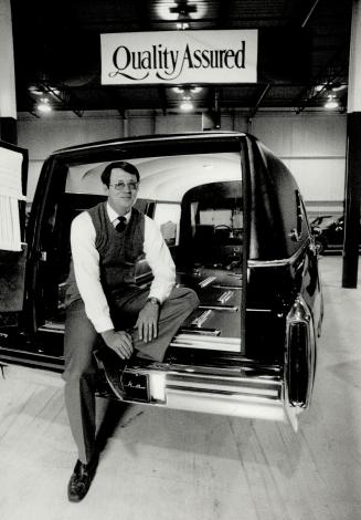 For final trips: Tom McPherson sits in the rear of one of the funeral hearses his Vaughan firm turns out